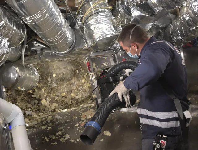 Wareham Air Duct Cleaning specialist operating negative pressure cleaning equipment for thorough duct maintenance in Wareham
