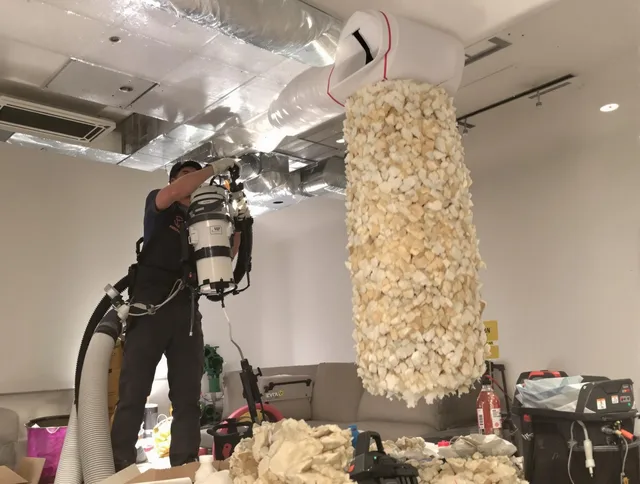 Wareham Air Duct Cleaning technician performing precision vacuum insulation removal in a residential property in Wareham